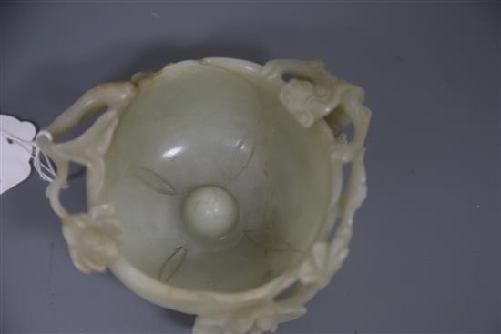 A Chinese pale celadon jade lotus cup, late Ming dynasty, W.13cm, associated wood stand